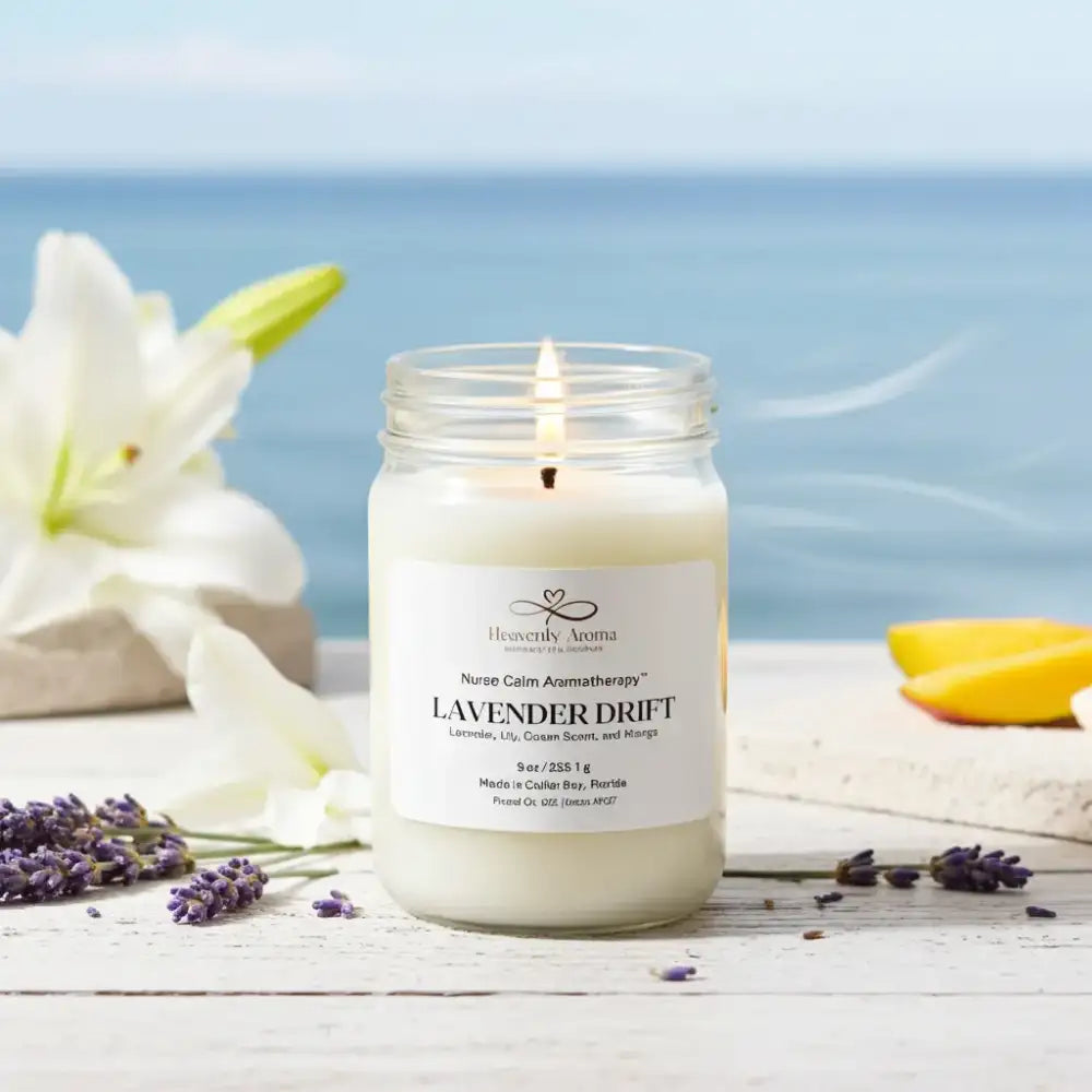 Candle in a jar labeled 'Lavender Drift' with flowers and ocean view in the background